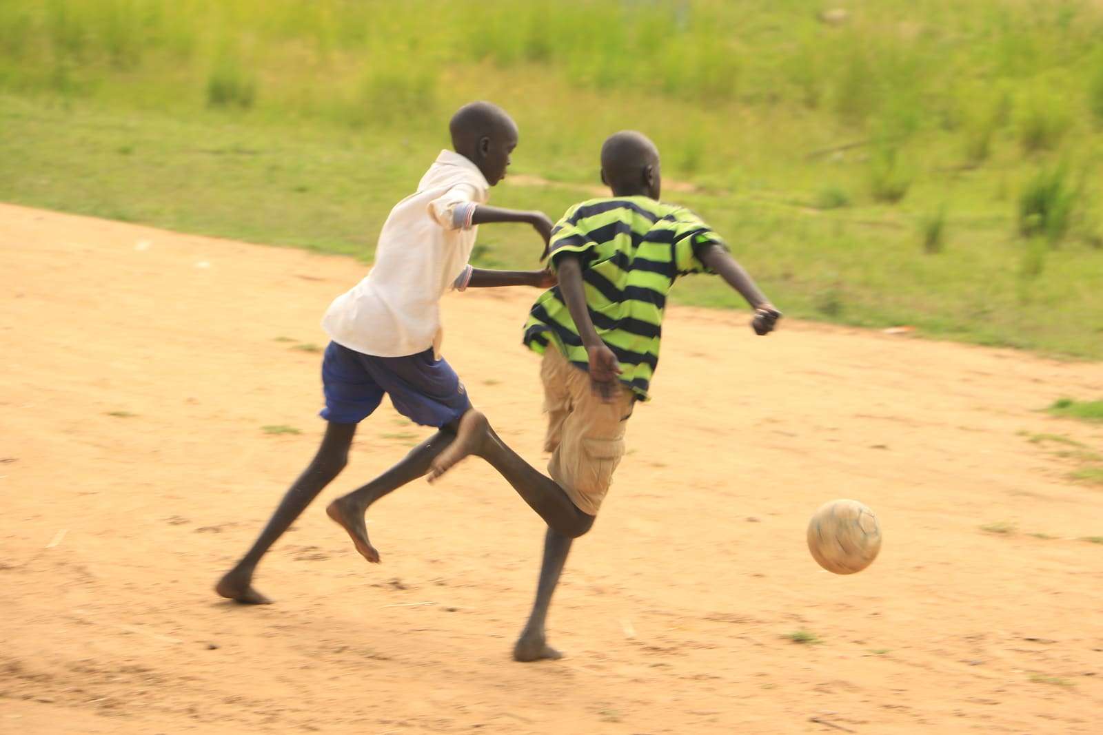 Two boys challenging for the ball